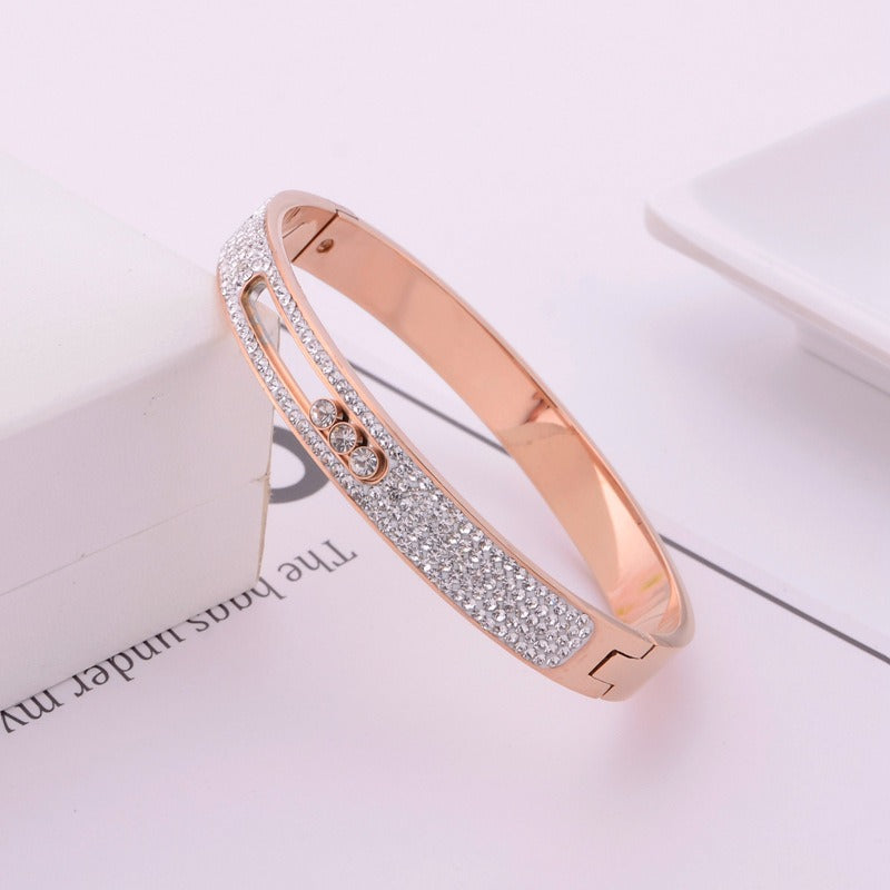 Rose gold titanium steel bracelet with three movable diamonds.