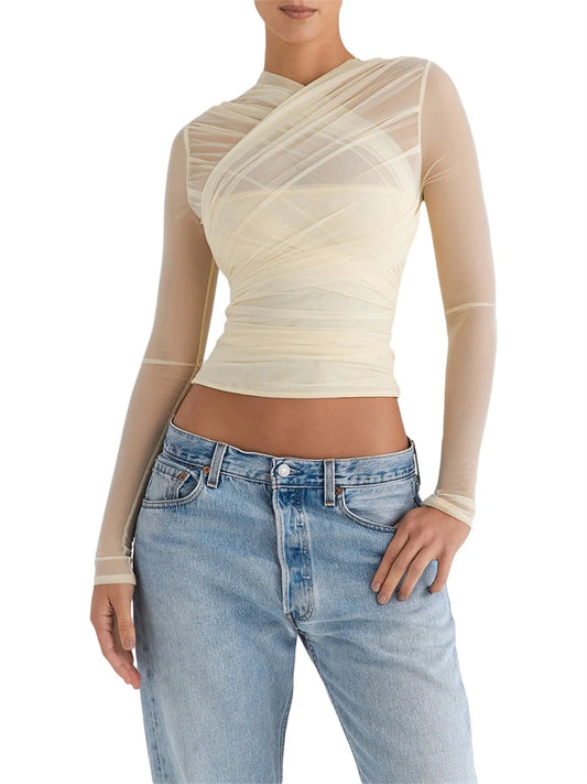 Cross-back zipper long sleeve top with sheer mesh waist detailing.