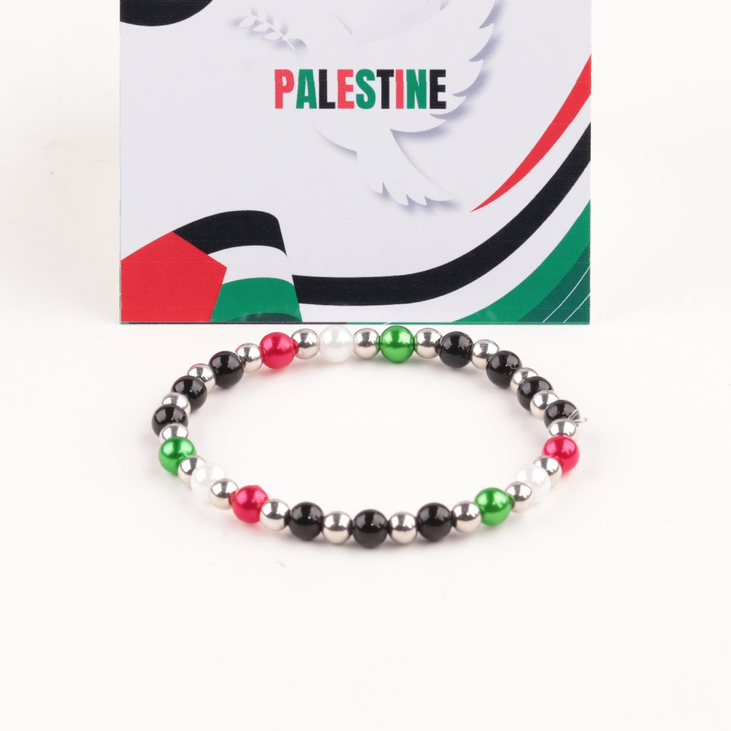 Palestine flag bracelet with silver, red, and green acrylic letter beads.