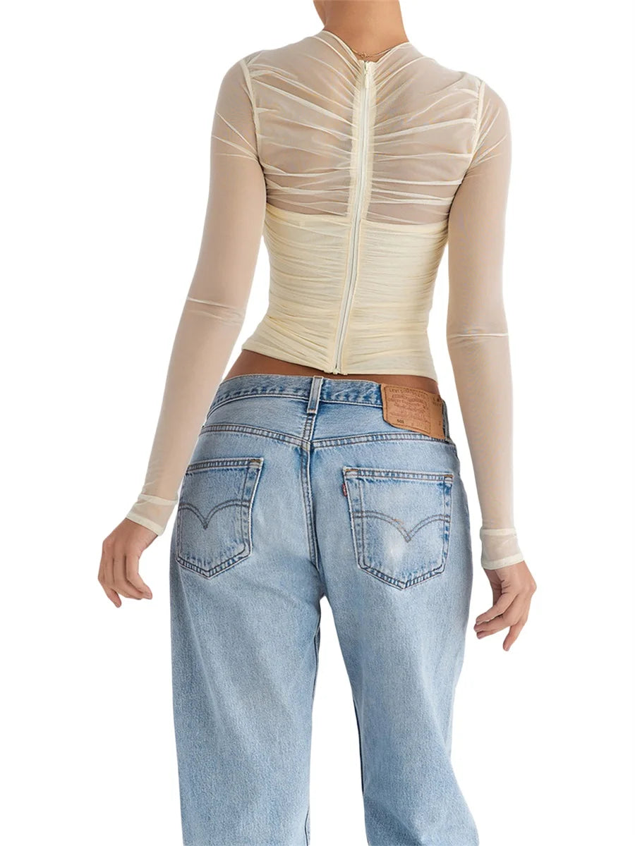 Cross-back zipper long sleeve top with sheer mesh waist detailing.