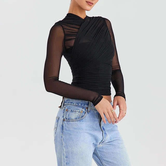 Cross-back zipper long sleeve top with sheer mesh waist detailing.