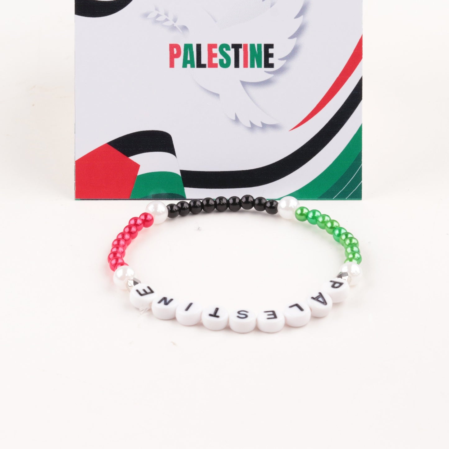 Palestine flag bracelet with silver, red, and green acrylic letter beads.