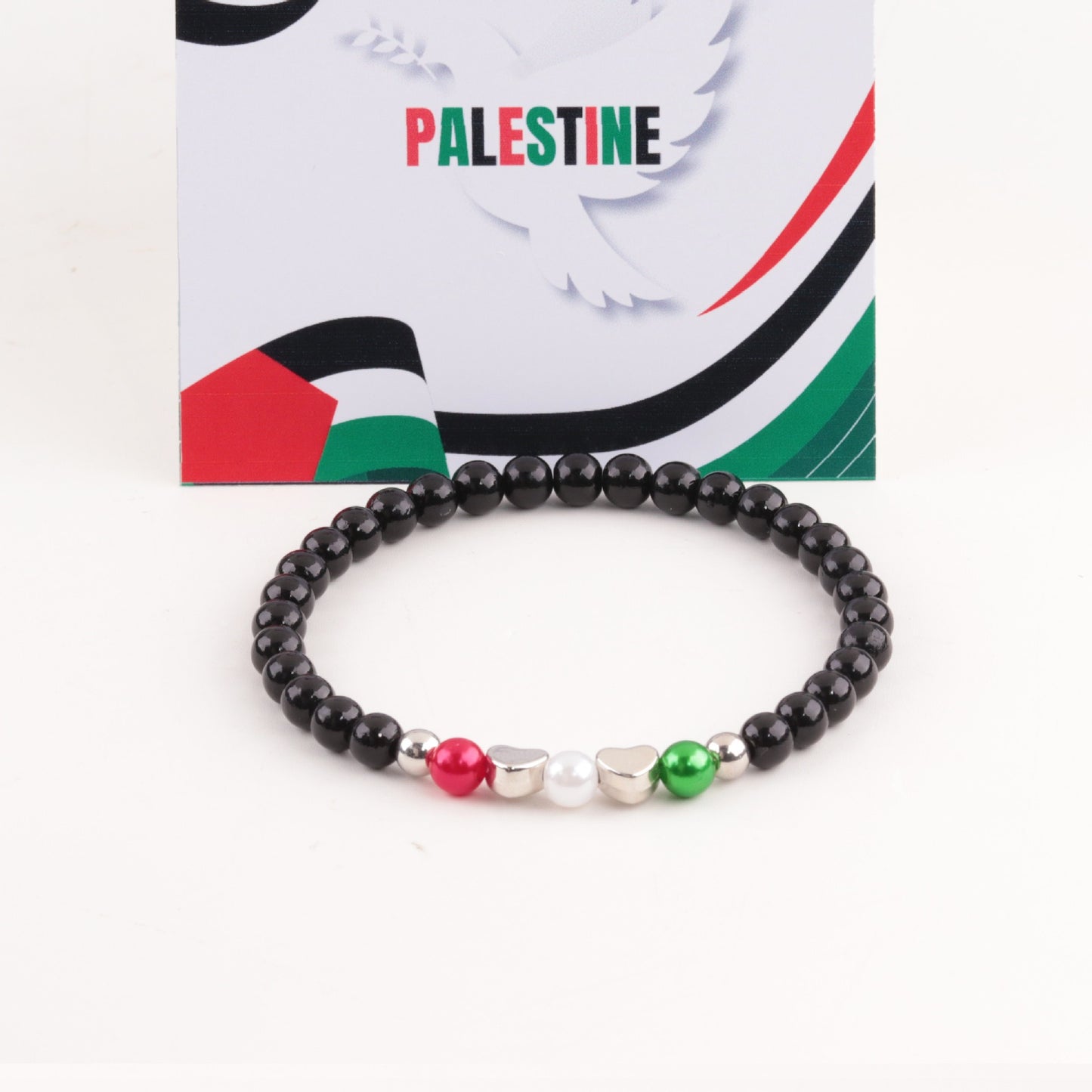 Palestine flag bracelet with silver, red, and green acrylic letter beads.